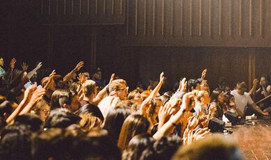 Audience with many hands in the air