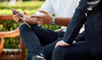 Businessmen sitting on bench, talking