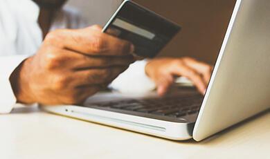 Man using credit card, on laptop