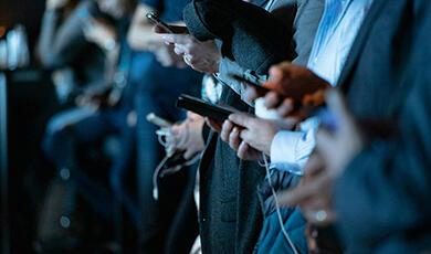 Men in suits looking at their phones