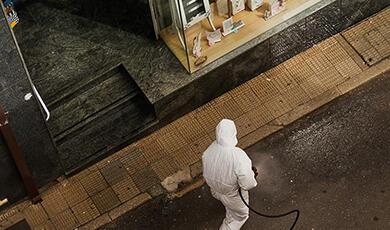 Person in hazmat suit walking in street