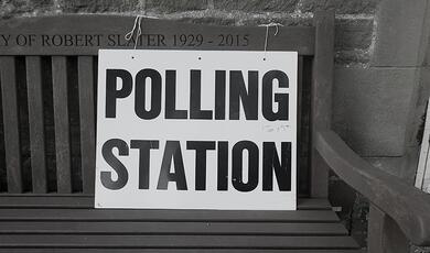 Polling booth sign on bench