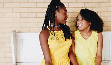 Two girls in yellow dresses