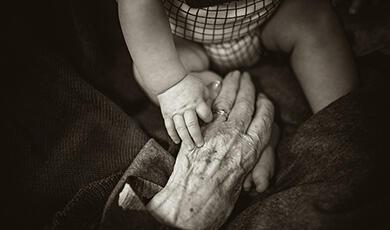 Child and old person holding hands