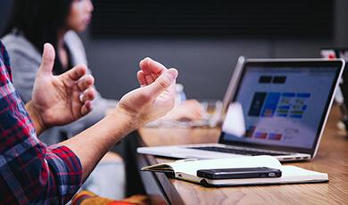 Person talking with laptop