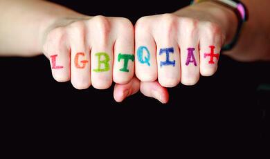 knuckles featuring the letters LGBTQIA in different colours