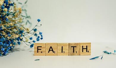 scrabble tiles spelling the word 'Faith'