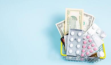 money and pill packets in a shopping basket