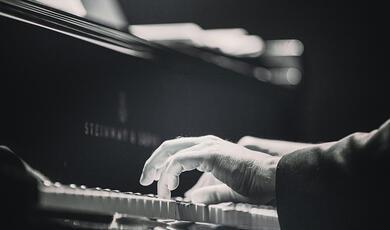 hands playing a piano