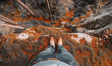 Downward view by man standing on edge of ciff