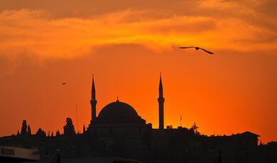 Silhouette of mosque against sunset
