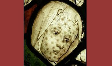 Spotted face of leper in stained glass