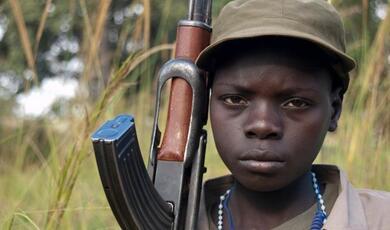 African child soldier carrying gun