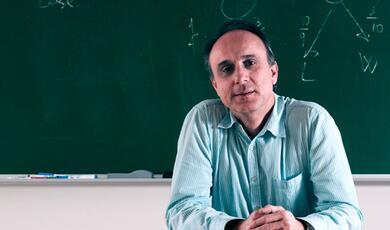 man sat in front of blackboard