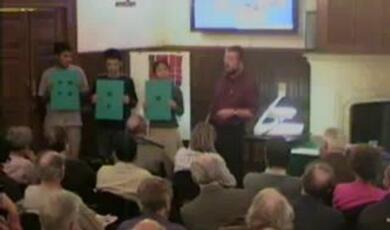 harold thimbleby, with three young people holding up grey cardboard signs