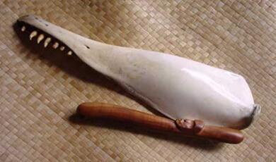 Tumutumu- a Māori musical instrument made from a whale's jaw bone and wood